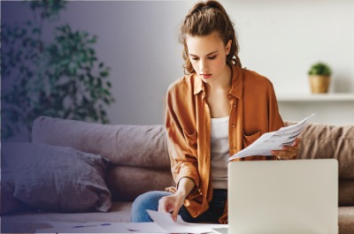 Woman with paperwork and laptop